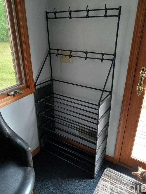 A small closet with a chair and a mat.