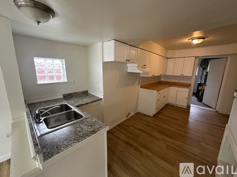 A kitchen with a sink and a window.
