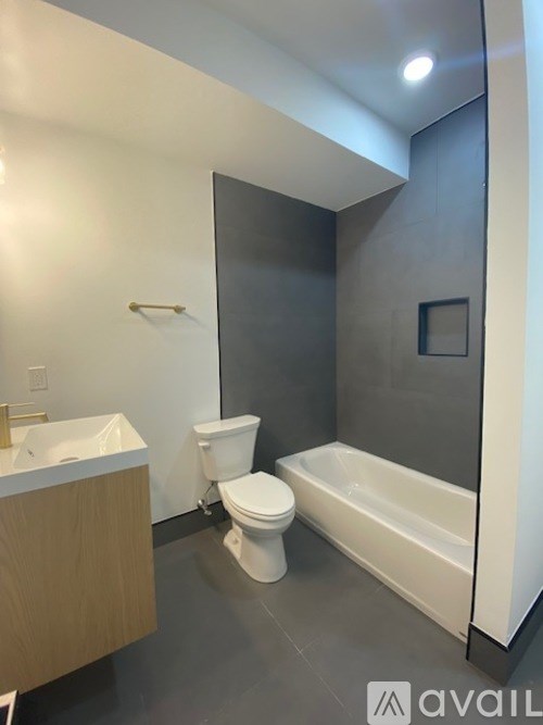 A bathroom with a toilet, sink, and bathtub.