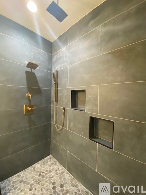 A bathroom with a shower and a tiled floor.