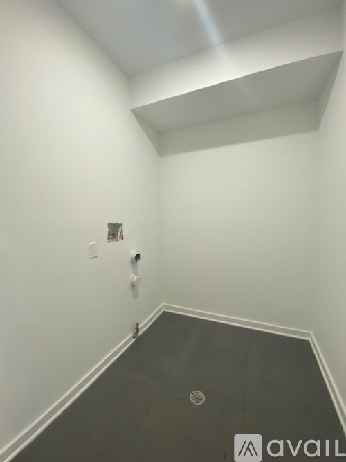 A room with a grey floor and white walls.
