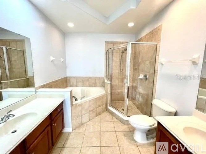 A bathroom with a white toilet, sink, and bathtub.