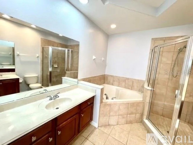 A bathroom with a sink, mirror, and bathtub.