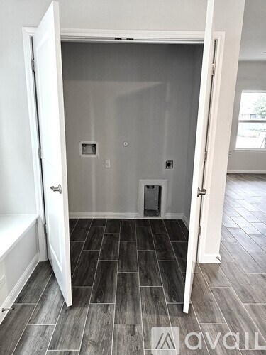 A room with a tiled floor and a white door.