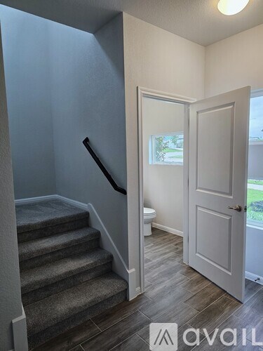 A hallway with a staircase leading to the second floor.