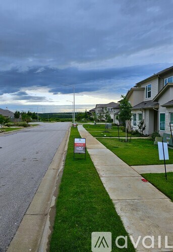 A street with a sign that says "avail" in the foreground.