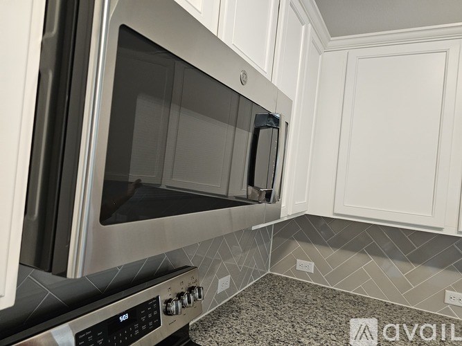 A modern kitchen with a stainless steel microwave oven.