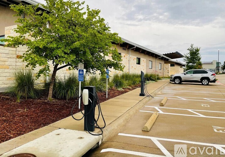 A parking lot with a charging station for electric vehicles.