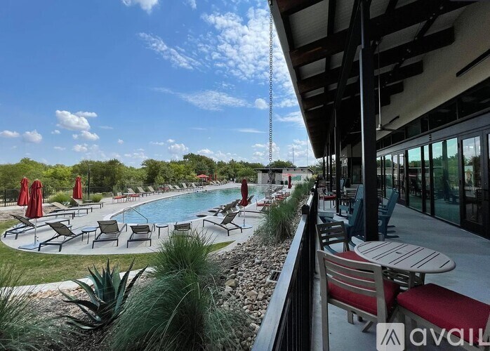 A pool area with lounge chairs and umbrellas is available for use.
