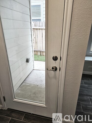 A white door with a glass window and a handle.
