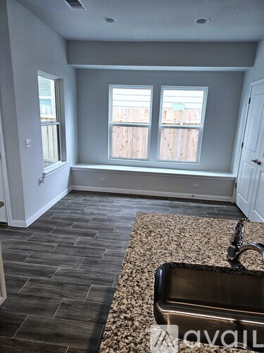 A kitchen with a sink and a window.