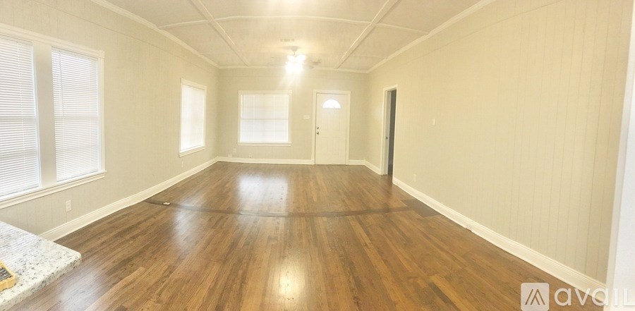 A room with wooden floors and white walls.
