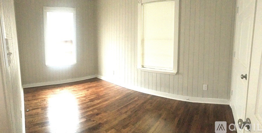 A room with wooden floors and white walls.