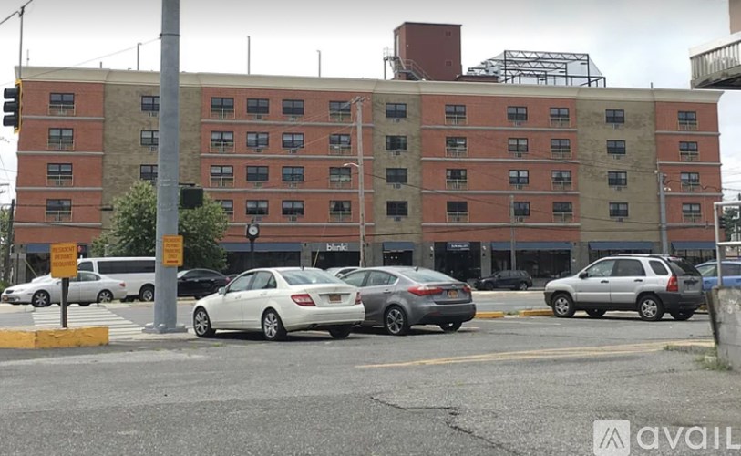 Cars parked in front of a brick building.