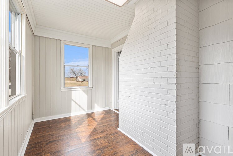 A room with white walls and a wooden floor.