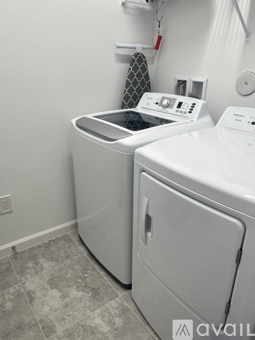 A washing machine and dryer in a small laundry room.