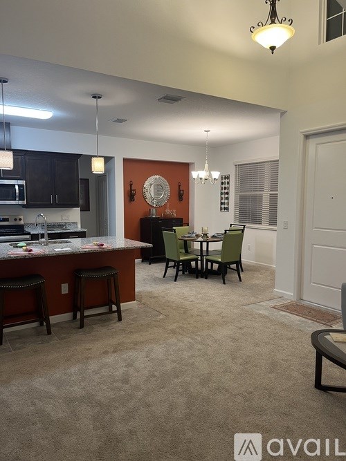 A kitchen with a bar area and a dining table.