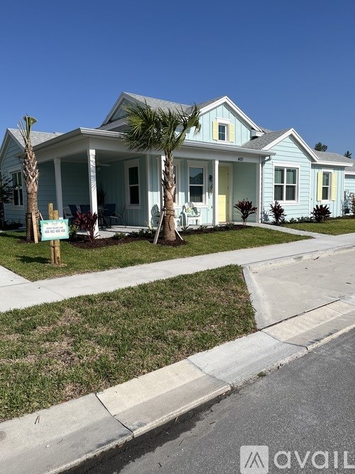 A house with a blue exterior and a white porch.