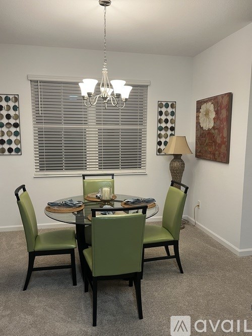 A dining room with a table set for four.