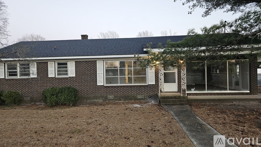 A house with a brick facade and a white door is available for purchase.