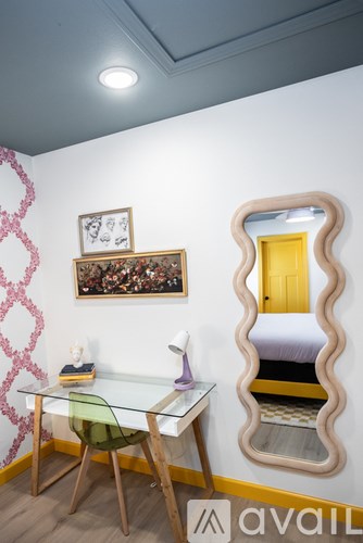 A room with a bed, desk, and chair.