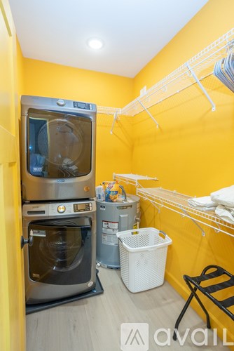 A small laundry room with a washer and dryer stacked on top of each other.