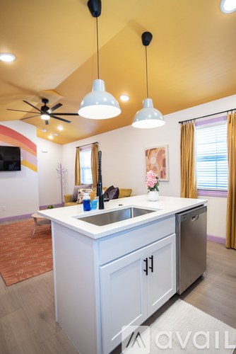 A kitchen with a white counter and a sink.