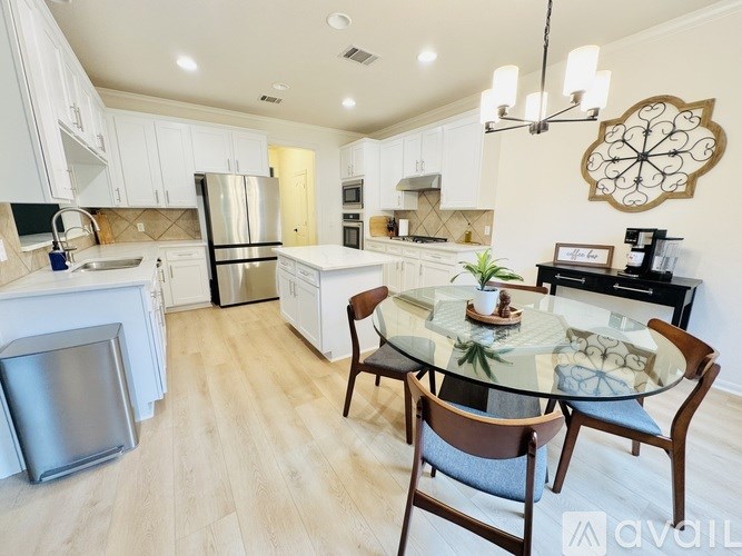 A modern kitchen with a glass table and chairs.