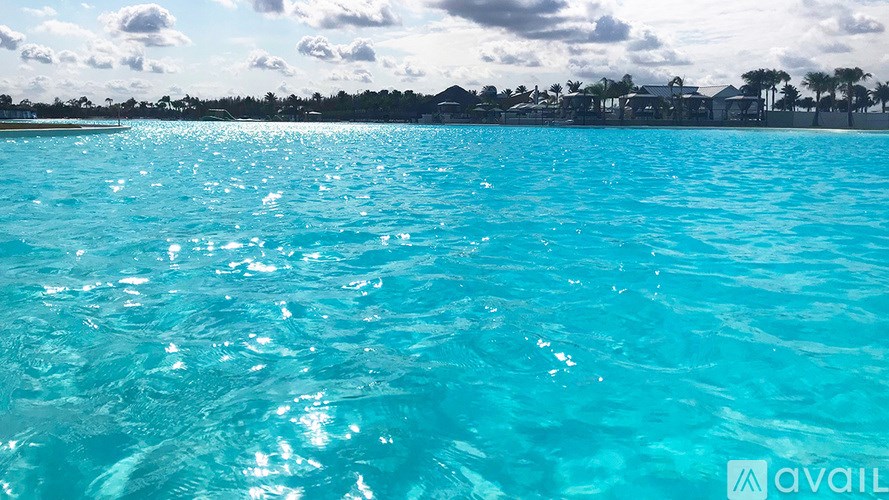 A clear blue water body with sunlight reflecting on it.