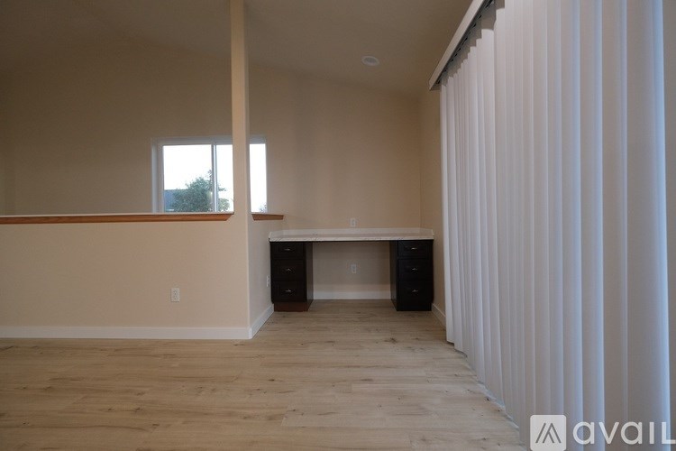 A room with a desk and a window.