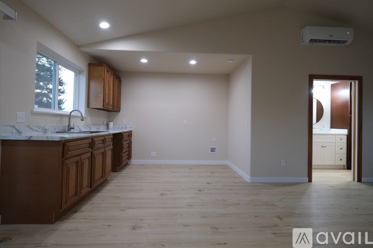 A kitchen with wooden cabinets and a marble countertop.