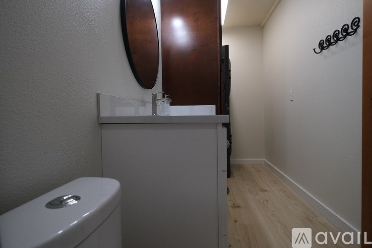 A bathroom with a toilet and a mirror.