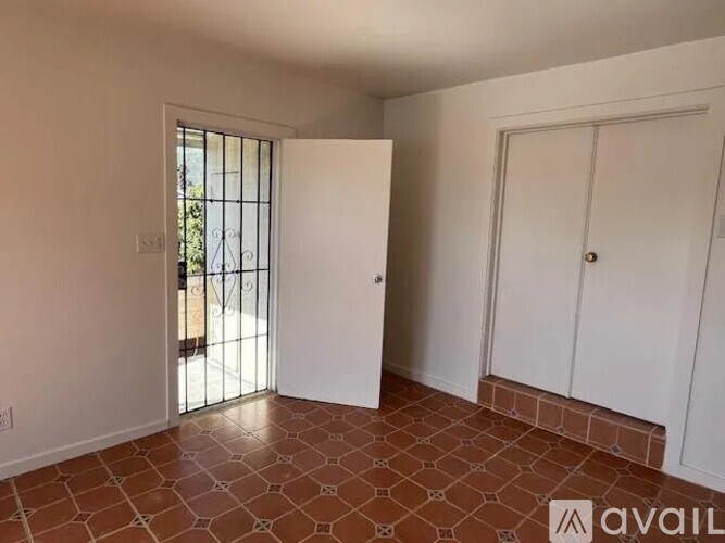 A room with a tiled floor and a door leading outside.