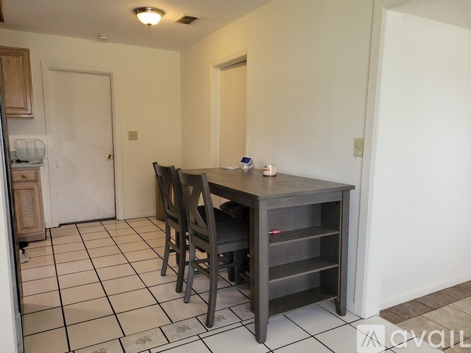 A dining area with a table and chairs.