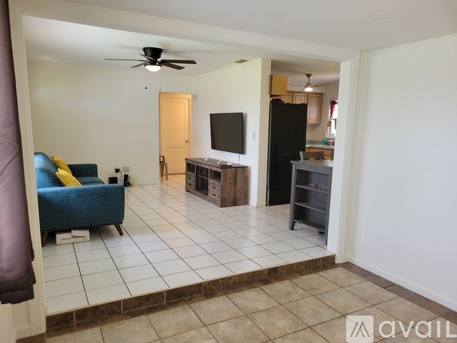 A living room with a blue couch and a television.