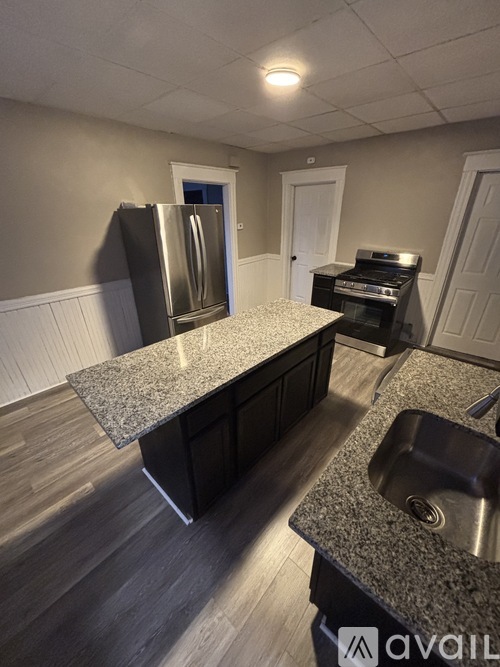 A kitchen with granite countertops and stainless steel appliances.