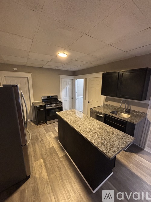 A room with a wooden floor and a white door.