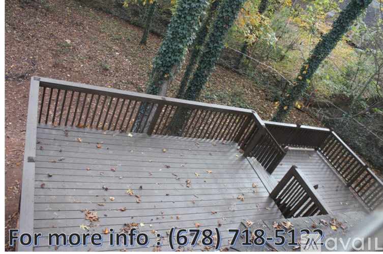 A wooden staircase with a railing leads up to a forest.
