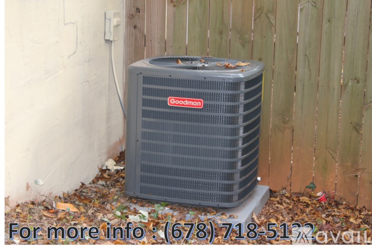 A Goodyear air conditioner unit is placed outside a house.