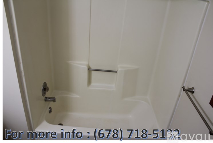 A white bathtub with a door and a handle.