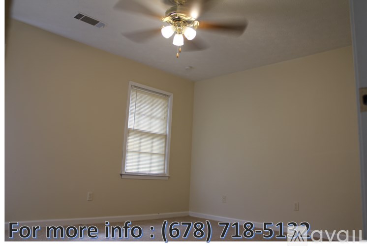 A room with a ceiling fan and a window.