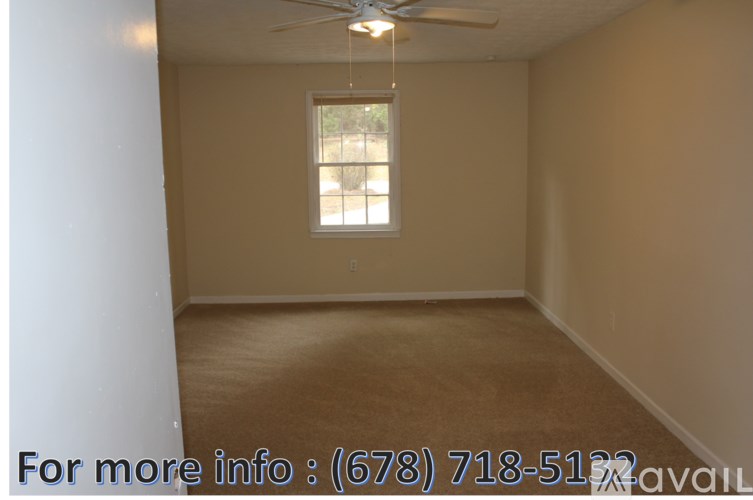 A room with a window and a ceiling fan.