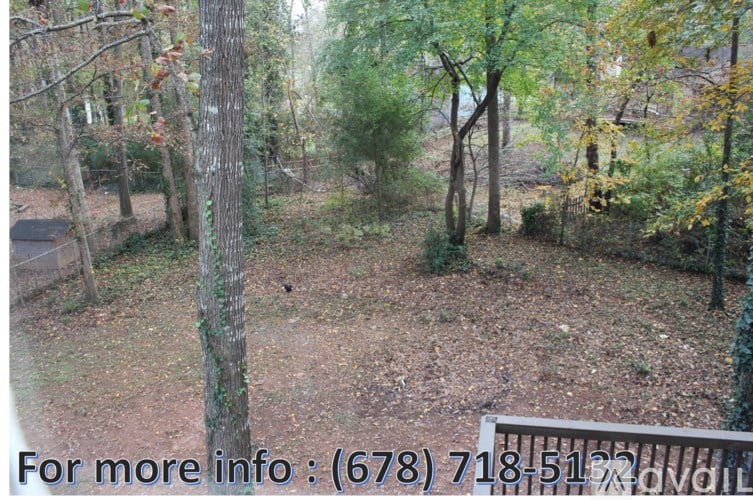 A wooded area with a phone number for more information.