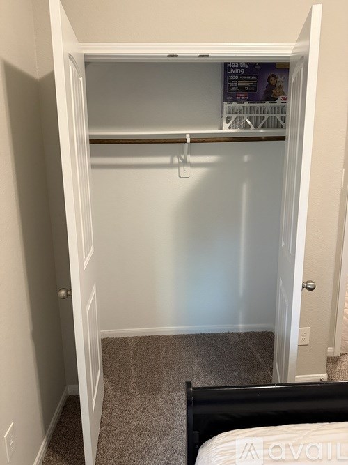 A small bedroom with a bed and a small closet.