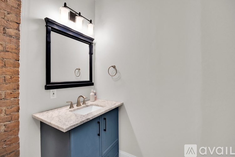A bathroom with a sink and a mirror above it.
