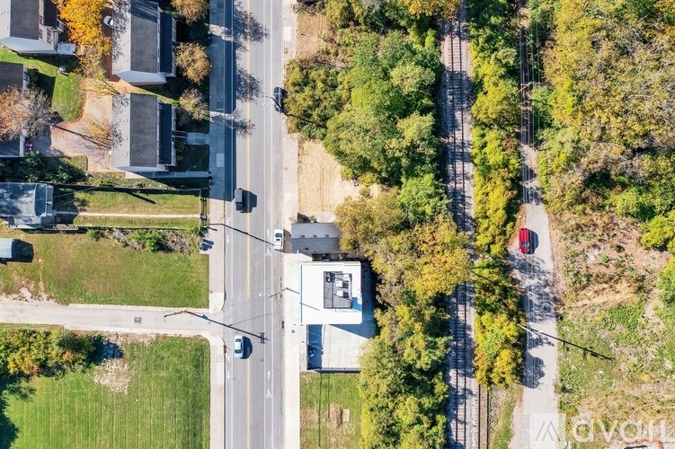 An aerial view of a street with cars and trees.