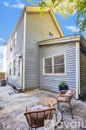 A house with a patio and chairs.