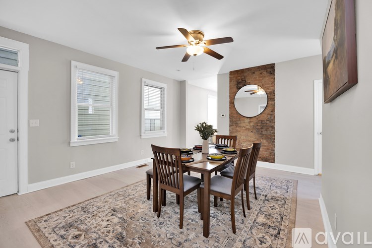 A dining room with a table set for four.
