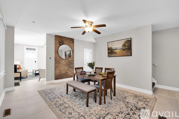 A dining room with a wooden table and chairs.