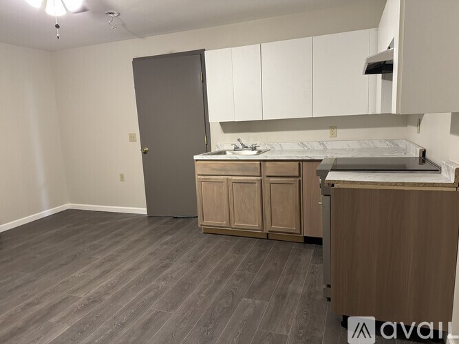 A kitchen area with a countertop and cabinets.
